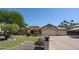 Inviting single-story home featuring a well-manicured lawn and a spacious three-car garage at 5521 W Northwood Dr, Glendale, AZ 85310