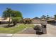 Attractive single-story home featuring a three-car garage and beautiful landscaping at 5521 W Northwood Dr, Glendale, AZ 85310