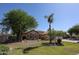 Well-manicured front yard featuring mature trees and lush lawn, enhancing the home's curb appeal at 5521 W Northwood Dr, Glendale, AZ 85310