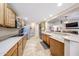 The kitchen features modern appliances, light wood cabinets, and an adjacent eat-in bar area at 5521 W Northwood Dr, Glendale, AZ 85310