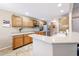 Bright kitchen featuring wooden cabinetry, stone countertops, and modern stainless steel appliances at 5521 W Northwood Dr, Glendale, AZ 85310