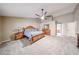 Spacious main bedroom with ceiling fan, carpet, and wooden furniture at 5521 W Northwood Dr, Glendale, AZ 85310