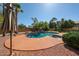 Gorgeous pool with rock landscaping, lush palms, and large patio area perfect for lounging and relaxation at 5521 W Northwood Dr, Glendale, AZ 85310