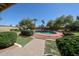 Backyard featuring a sparkling blue pool, lush landscaping, and a patio, perfect for outdoor entertaining at 5521 W Northwood Dr, Glendale, AZ 85310