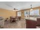 Cozy dining area featuring tile floors, a ceiling fan, and natural lighting at 7326 E Juanita Ave, Mesa, AZ 85209