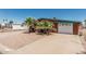 Welcoming exterior featuring a white garage door, rock landscaping and mature palm trees at 7326 E Juanita Ave, Mesa, AZ 85209