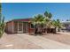 Cozy home with rock landscaping, palm trees, covered patio and neutral exterior paint at 7326 E Juanita Ave, Mesa, AZ 85209