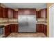 Kitchen features brown cabinets, stainless appliances, tile countertops, and tile floors at 7326 E Juanita Ave, Mesa, AZ 85209