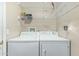 This laundry room features a modern washer and dryer and wire rack shelving at 7326 E Juanita Ave, Mesa, AZ 85209