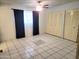 Bedroom with tile floors, a ceiling fan, and a closet at 7525 W Turney Ave, Phoenix, AZ 85033