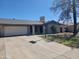 Charming single-story home featuring a two-car garage and established front yard at 7525 W Turney Ave, Phoenix, AZ 85033