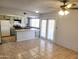 Open kitchen with tile floors, light green cabinets and eat in kitchen space at 7525 W Turney Ave, Phoenix, AZ 85033