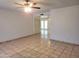 Spacious Living Room with tile floors, ceiling fan, and access to the backyard at 7525 W Turney Ave, Phoenix, AZ 85033