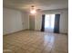 Bright and airy living room featuring neutral walls, tile floors, and a ceiling fan at 7525 W Turney Ave, Phoenix, AZ 85033