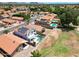 Beautiful aerial view of a home with a pristine pool, solar panels, and a well-maintained residential neighborhood at 7535 W Kimberly Way, Glendale, AZ 85308