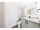 Updated bathroom featuring a modern vanity, sleek fixtures, and a stylish, illuminated mirror at 7535 W Kimberly Way, Glendale, AZ 85308