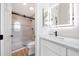 Bright bathroom with modern vanity, decorative mirror, and tiled walk-in shower at 7535 W Kimberly Way, Glendale, AZ 85308