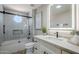 Updated bathroom with a shower over tub, white vanity, framed mirror, and modern fixtures at 7535 W Kimberly Way, Glendale, AZ 85308
