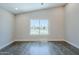 Spacious bedroom with hardwood floors and a large window overlooking the neighborhood at 7535 W Kimberly Way, Glendale, AZ 85308