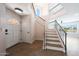 Bright foyer with hardwood floors, a staircase with iron railings, and a view of the upper level at 7535 W Kimberly Way, Glendale, AZ 85308