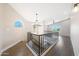 Upstairs hallway with wood floors, a chandelier, and a view into other rooms at 7535 W Kimberly Way, Glendale, AZ 85308