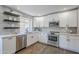 Modern kitchen with white cabinets, stainless steel appliances, and beautiful countertops at 7535 W Kimberly Way, Glendale, AZ 85308