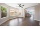 Spacious living room featuring hardwood floors, large windows for ample natural light, and an archway to the entry hall at 7535 W Kimberly Way, Glendale, AZ 85308