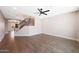 Open-concept living room with wood floors, staircase with black metal railings, and recessed lighting at 7535 W Kimberly Way, Glendale, AZ 85308