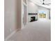 Cozy living room featuring a fireplace, vaulted ceiling, and light carpet at 7535 W Kimberly Way, Glendale, AZ 85308