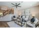 Inviting living room with comfortable seating, stylish decor, and a modern staircase at 7535 W Kimberly Way, Glendale, AZ 85308