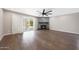 Bright living room features hardwood floors, a ceiling fan and backyard access at 7535 W Kimberly Way, Glendale, AZ 85308