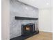 Close up of modern gas fireplace with gray marble and black trim at 7535 W Kimberly Way, Glendale, AZ 85308
