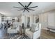 Open-concept living room with stylish seating, a ceiling fan, and seamless flow to the kitchen at 7535 W Kimberly Way, Glendale, AZ 85308