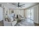 Bright living room with stylish seating, a large ceiling fan, and a view of the backyard at 7535 W Kimberly Way, Glendale, AZ 85308