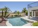 Backyard featuring a lush pool, a well-manicured lawn, and mature trees for privacy at 7535 W Kimberly Way, Glendale, AZ 85308