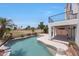Inviting pool area with decorative rock features, palm trees, and spacious patio, perfect for outdoor relaxation at 7535 W Kimberly Way, Glendale, AZ 85308