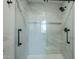 Modern glass enclosed shower featuring sleek hardware, modern fixtures, and beautiful tile surround at 7535 W Kimberly Way, Glendale, AZ 85308
