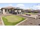 Large landscaped backyard features a gazebo, mini golf, a fire pit and gravel perfect for outdoor entertaining at 7575 W Darrel Rd, Laveen, AZ 85339