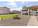Spacious backyard featuring a gazebo, patio, turf, a gravel area, and a fire pit for outdoor enjoyment at 7575 W Darrel Rd, Laveen, AZ 85339