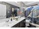 Bathroom with a double vanity, modern fixtures, wallpaper and a bathtub with stylish shower curtain at 7575 W Darrel Rd, Laveen, AZ 85339
