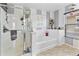 Serene bathroom featuring a separate shower and tub, complemented by stylish striped walls at 7575 W Darrel Rd, Laveen, AZ 85339