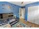 Blue themed bedroom featuring hardwood flooring, decorated walls, a ceiling fan, closet, and -friendly designs at 7575 W Darrel Rd, Laveen, AZ 85339