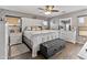 Stylish bedroom boasts a decorative accent wall, white furnishings, and warm wood-look floors at 7575 W Darrel Rd, Laveen, AZ 85339