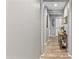 Well-lit hallway with hardwood flooring, and neutral walls provides a clean and inviting transition between rooms at 7575 W Darrel Rd, Laveen, AZ 85339