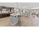 Open-concept kitchen with an island, stainless appliances, dark cabinetry and barstool seating at 7575 W Darrel Rd, Laveen, AZ 85339