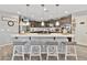 Bright open-concept kitchen featuring an island with barstool seating, stylish pendant lighting and backsplash at 7575 W Darrel Rd, Laveen, AZ 85339