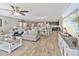 Bright open-concept living area with hardwood floors flowing seamlessly into kitchen and dining space at 7575 W Darrel Rd, Laveen, AZ 85339