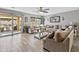 Cozy living room with a large sectional couch, hardwood floors, and a sliding door to the patio at 7575 W Darrel Rd, Laveen, AZ 85339