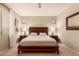 A primary bedroom features a wood bed frame, neutral walls, carpet flooring, and natural light at 7617 E Desert Honeysuckle Dr, Gold Canyon, AZ 85118