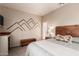 Inviting bedroom with unique headboard, patterned carpet and geometric wall decor at 7617 E Desert Honeysuckle Dr, Gold Canyon, AZ 85118